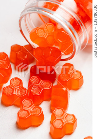 Jelly gummies close-up, fruit vitamins on bright background, food supplements.Orange vitamins in a jar 138780330