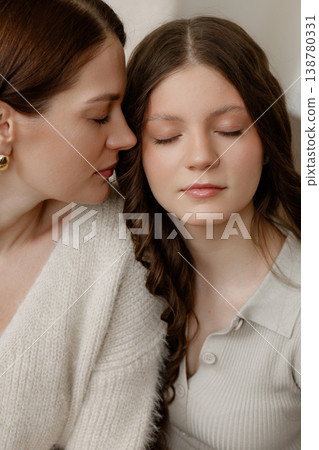 Serene Mother Tenderly Cradles And Calms Her Upset Daughter With Loving Gestures 138780331
