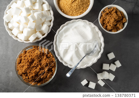 Light brown, dark brown and white sugar cubes in bowls. Different type of sugar Light brown, dark brown and white sugar cubes in bowls. Different type of sugar 138780371