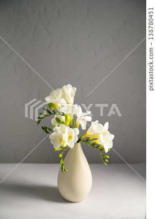 White floral spring, easter background. Freesia white flowers in vase, copy space White floral spring, easter background. Freesia white flowers in vase, copy space 138780451
