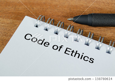 Code of Ethics text written on notepad representing business and office conduct. Code of Ethics text written on notepad representing business and office conduct. 138780614