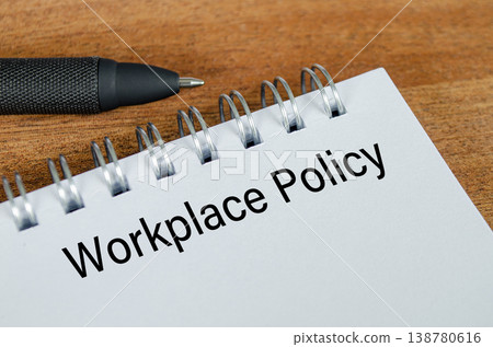 Workplace policy written on paper representing office rules, compliance, and employee guidance. Workplace policy written on paper representing office rules, compliance, and employee guidance. 138780616