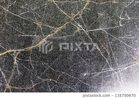 Goldenveined dark marble surface. Polished black marble featuring gold streaks and sparkle 138780670