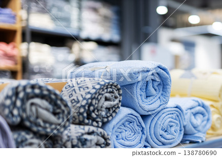 Soft towels arranged on shelves. Neatly stacked towels with plush textures and patterns Soft towels arranged on shelves. Neatly stacked towels with plush textures and patterns 138780690