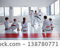 Children practicing martial arts drills under instructor supervision 138780771