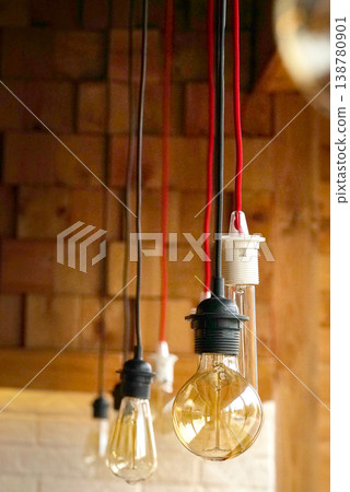 Vintage light bulbs suspended from a wire. Hanging retro incandescent lamps. closeup Vintage light bulbs suspended from a wire. Hanging retro incandescent lamps. closeup 138780901