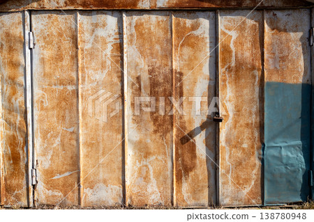 The large metal garage shows signs of rust and wear. The area is open and well-lit, reflecting daylight clearly The large metal garage shows signs of rust and wear. The area is open and well-lit, reflecting daylight clearly 138780948