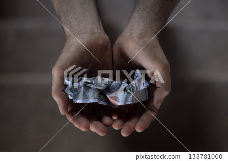 Dirty hands holding crumpled dollar bills, Poverty and inequality 138781000
