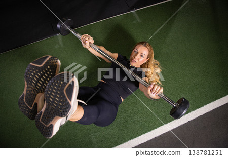 Fitness and health concept. A fit young woman works out in a modern gym. Athletic man doing exercise. Fitness and health concept. A fit young woman works out in a modern gym. Athletic man doing exercise. 138781251
