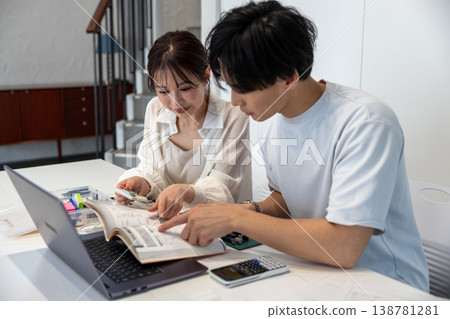 Young men and women studying electronic circuits Young men and women studying electronic circuits 138781281