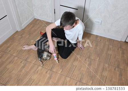 young bearded man with a dalmatian dog against white brick wall background young bearded man with a dalmatian dog against white brick wall background 138781533