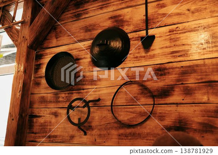 Wooden wall with traditional metal sac and cooking tools used for Balkan pita and burek preparation. Concept of regional cuisine, culinary heritage and authentic restaurant decor Wooden wall with traditional metal sac and cooking tools used for Balkan pita and burek preparation. Concept of regional cuisine, culinary heritage and authentic restaurant decor 138781929