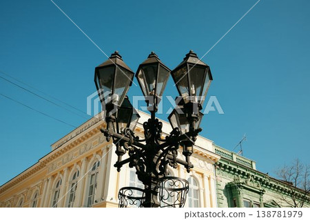 Decorative street lamp with multiple lanterns in front of historic European building. Concept of urban design, heritage architecture and city atmosphere Decorative street lamp with multiple lanterns in front of historic European building. Concept of urban design, heritage architecture and city atmosphere 138781979