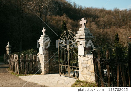 Courtyard and entrance gate of Ribnica Monastery surrounded by forest landscape near Mionica Serbia. Religious complex representing faith spirituality heritage pilgrimage and cultural tradition Courtyard and entrance gate of Ribnica Monastery surrounded by forest landscape near Mionica Serbia. Religious complex representing faith spirituality heritage pilgrimage and cultural tradition 138782025