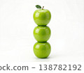 Geometric Stack of Three Different Green Apples with Stems Isolated on a Solid White Background 138782192