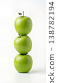 Geometric Stack of Three Different Green Apples with Stems Isolated on a Solid White Background 138782194