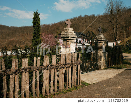 Stone gate with Orthodox crosses and iron entrance to Ribnica Monastery near Mionica Serbia. Religious architecture representing faith spirituality pilgrimage heritage and tradition Stone gate with Orthodox crosses and iron entrance to Ribnica Monastery near Mionica Serbia. Religious architecture representing faith spirituality pilgrimage heritage and tradition 138782919