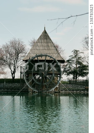 Traditional wooden watermill with large wheel above lake in Stanisici Ethno Village near Bijeljina Bosnia and Herzegovina. Concept of historic engineering rural heritage and tourism Traditional wooden watermill with large wheel above lake in Stanisici Ethno Village near Bijeljina Bosnia and Herzegovina. Concept of historic engineering rural heritage and tourism 138783825