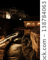 Residential buildings on a hillside at night with warm window lights and stone walls near river in the historic area of Mostar, Bosnia and Herzegovina 138784063