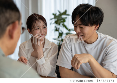 A young couple is consulting with a contractor about building a house. 138784473