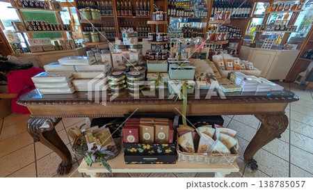 Gift boxes of local sweets are displayed in front of shelves of local liquor bottles in a gourmet gift shop Gift boxes of local sweets are displayed in front of shelves of local liquor bottles in a gourmet gift shop 138785057