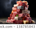 Colorful assortment of various cuts of meat displayed in a stacked arrangement on a dark background 138785843