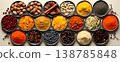 Colorful assortment of spices and nuts arranged in bowls on a smooth surface showcasing  138785848