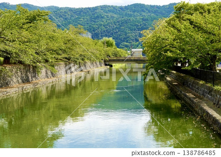 Kyoto: A view of the Higashiyama mountains reflected in the Lake Biwa Canal south of the Kyoto City Museum of Art, Higashiyama Ward, Kyoto City. 138786485