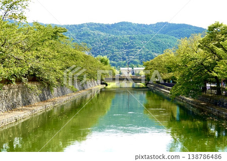 Kyoto: A view of the Higashiyama mountains reflected in the Lake Biwa Canal south of the Kyoto City Museum of Art, Higashiyama Ward, Kyoto City. Kyoto: A view of the Higashiyama mountains reflected in the Lake Biwa Canal south of the Kyoto City Museum of Art, Higashiyama Ward, Kyoto City. 138786486