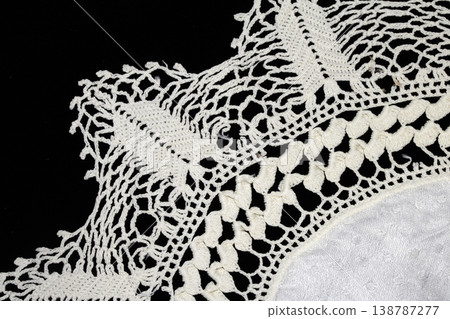 Close up of vintage lace fabric white on black background embroidery Close up of vintage lace fabric white on black background embroidery 138787277