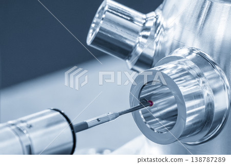 High-precision multi-axis CMM machine measuring the inside hole diameter of an aluminum part in a modern industrial setting. High-precision multi-axis CMM machine measuring the inside hole diameter of an aluminum part in a modern industrial setting. 138787289