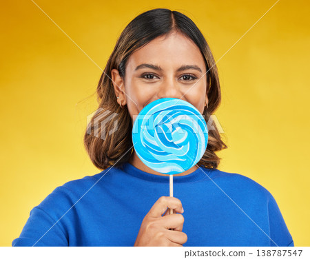 Lollipop, candy and portrait of woman with sweet dessert with sugar isolated in a studio yellow background with smile. Food, snack and young person with delicious treats, product or guilty pleasure Lollipop, candy and portrait of woman with sweet dessert with sugar isolated in a studio yellow background with smile. Food, snack and young person with delicious treats, product or guilty pleasure 138787547