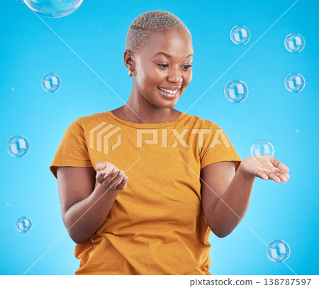 Black woman, playing with bubbles and happiness, fun and vibrant with entertainment on blue background. Liquid soap, freedom and African female person, playful with activity and enjoy in studio Black woman, playing with bubbles and happiness, fun and vibrant with entertainment on blue background. Liquid soap, freedom and African female person, playful with activity and enjoy in studio 138787597