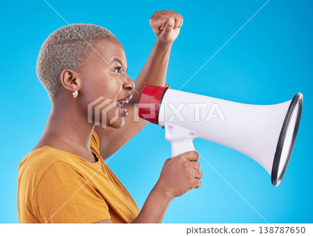 Black woman, megaphone and protest in studio, shout or profile with fist in air for human rights by blue background. African gen z student, girl and audio tech for power, opinion or news announcement Black woman, megaphone and protest in studio, shout or profile with fist in air for human rights by blue background. African gen z student, girl and audio tech for power, opinion or news announcement 138787650