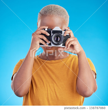 Photographer woman, retro camera and studio for journalist job, art or photoshoot by blue background. African girl, lens and tech for creativity, production or content creation for paparazzi magazine Photographer woman, retro camera and studio for journalist job, art or photoshoot by blue background. African girl, lens and tech for creativity, production or content creation for paparazzi magazine 138787860