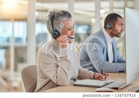 Computer, smile and an elderly woman in a call center for customer service, support or assistance online. Contact, headset and a happy senior consultant working at a desk in a professional crm office 138787918