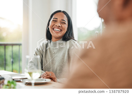 Smile, dinner and woman laughing or happy at a table for a gathering event in a funny family home at lunch. Joke, happiness and young person at a celebration with unity meal or supper in dining room 138787920