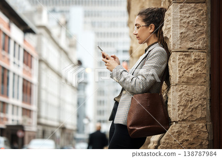City wall, phone and business woman typing online research, reading email and scroll on website, app or social media. Urban sidewalk, cellphone and professional person relax on outdoor work break 138787984