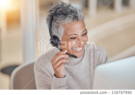 Computer, smile and a senior woman in a call center for customer service, support or assistance online. Contact, headset and a happy female consultant working at a desk in her professional crm office 138787990
