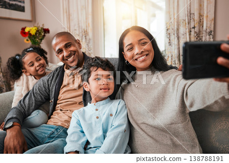 Family, selfie and children with parents on sofa for social media, online memory and happy together at home. Interracial people, kids with mother and father smile in profile picture or photography 138788191