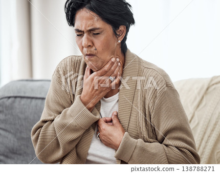 Senior woman, cough and sick on sofa in home, chest pain and pneumonia with tuberculosis or choke. Pensioner, mature lady or sore throat with lung infection, breathing problem and choking with asthma Senior woman, cough and sick on sofa in home, chest pain and pneumonia with tuberculosis or choke. Pensioner, mature lady or sore throat with lung infection, breathing problem and choking with asthma 138788271