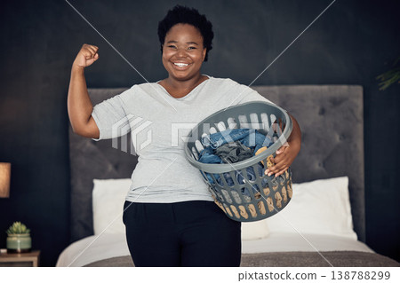 Black woman, clothes in basket and champion, success in cleaning and bedroom with hygiene in portrait. Strong female cleaner, winner at housekeeping with smile, laundry and maintenance at home Black woman, clothes in basket and champion, success in cleaning and bedroom with hygiene in portrait. Strong female cleaner, winner at housekeeping with smile, laundry and maintenance at home 138788299