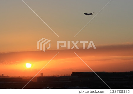A passenger plane ascending against the backdrop of the setting sun. A passenger plane ascending against the backdrop of the setting sun. 138788325