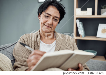 Smile, relax and an old woman writing in her journal while sitting in the living room of her retirement home. Notebook, pen and a happy senior female pensioner on a sofa, taking notes in a diary Smile, relax and an old woman writing in her journal while sitting in the living room of her retirement home. Notebook, pen and a happy senior female pensioner on a sofa, taking notes in a diary 138788328