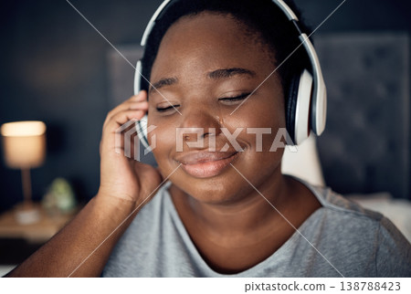 Crying, happy and black woman with headphones for music, sound or audio. Tears, radio and plus size African person listening, hearing and streaming podcast for peace or relax in home bedroom at night Crying, happy and black woman with headphones for music, sound or audio. Tears, radio and plus size African person listening, hearing and streaming podcast for peace or relax in home bedroom at night 138788423