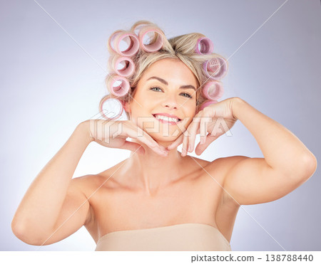 Hair care, rollers and portrait of woman in a studio doing a natural, beautiful and curly hairstyle. Self care, happy and attractive female model with curlers for beauty isolated by a gray background 138788440