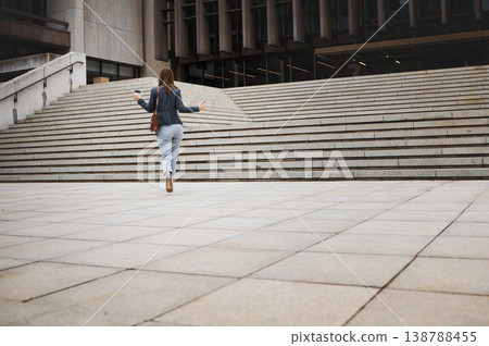 Walking, travel and business woman in city with ambition for morning commute, journey and building. Professional, growth and back of female person by steps for career progress, work and job in town 138788455