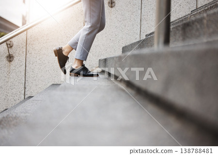 Stairs, morning person and legs walk, travel or on urban journey, outdoor commute or trip to work, destination or job. Town steps, arrival and closeup shoes, feet or agent climbing building staircase Stairs, morning person and legs walk, travel or on urban journey, outdoor commute or trip to work, destination or job. Town steps, arrival and closeup shoes, feet or agent climbing building staircase 138788481