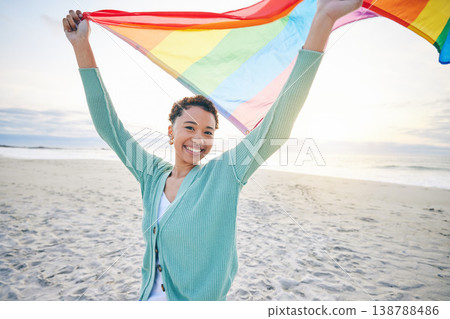 Woman, beach and pride flag for lgbtq in portrait, smile and wind with wave, rainbow and equality for inclusion. African girl, fabric or cloth for human rights, lesbian sexuality or happy on vacation Woman, beach and pride flag for lgbtq in portrait, smile and wind with wave, rainbow and equality for inclusion. African girl, fabric or cloth for human rights, lesbian sexuality or happy on vacation 138788486
