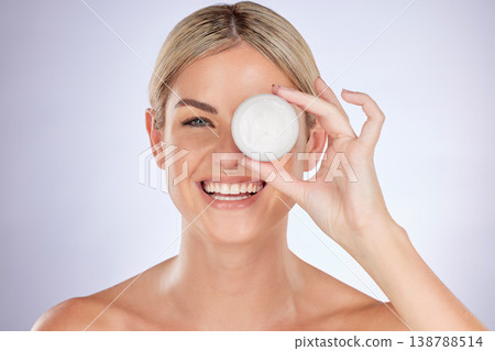 Skincare, studio portrait and happy woman with cream container for facial hydration, beauty care or collagen glow. Face lotion, cosmetics and person with acne prevention product on purple background 138788514